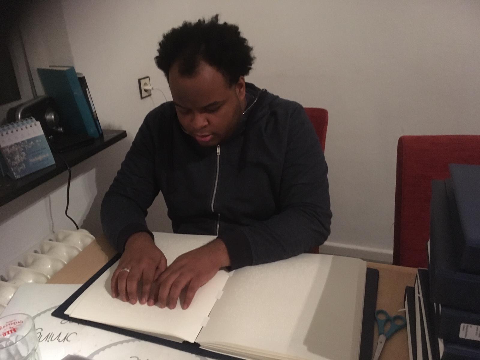 Arbeiten im Homeoffice:Johannes liest in der Blindenschrift-Bibel